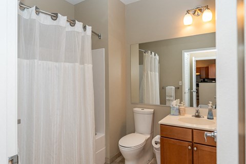 50 WB's furnished apartment showing a bathroom with a shower and a toilet and a sink